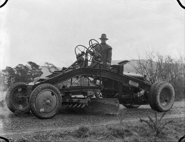 1024px-A_grader_working_on_the_road_at_Upper_Hutt,_1936_ATLIB_306472-1