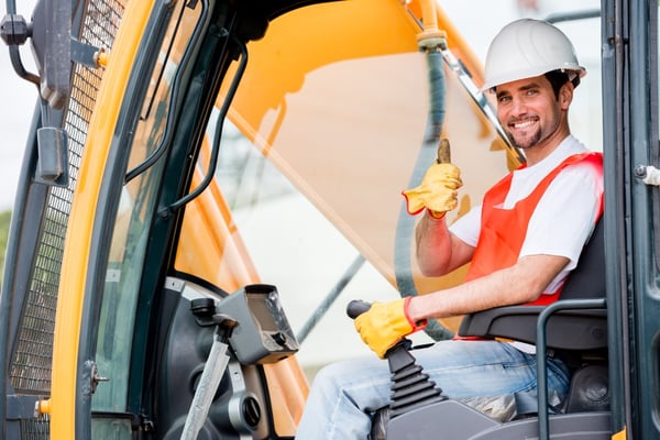 Crane operator at a construction site looking happy