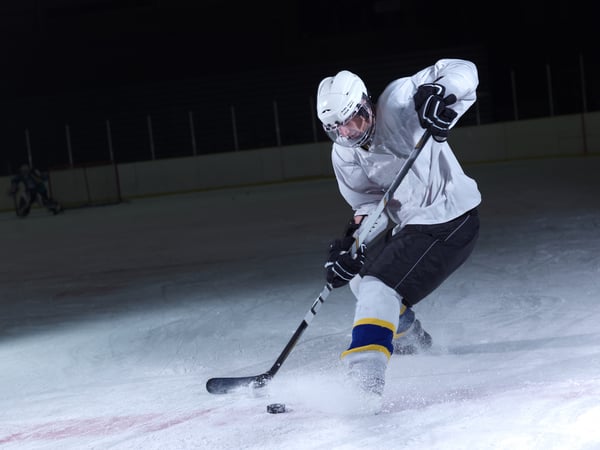 ice hockey player in action kicking with stick