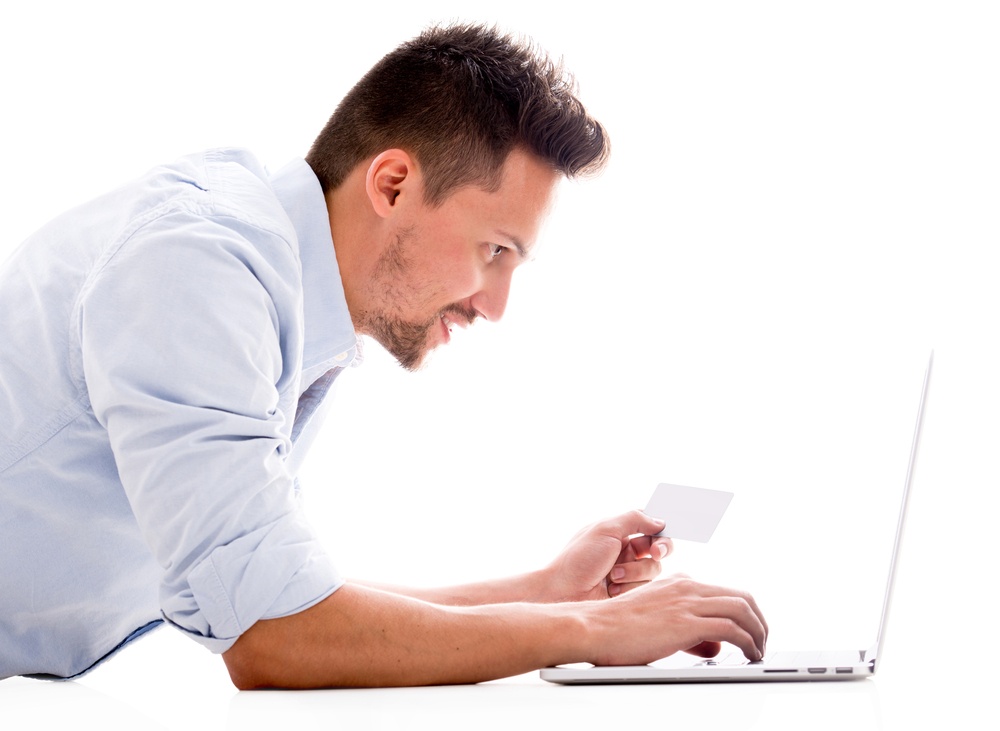 Man shopping online with a credit card - isolated over white